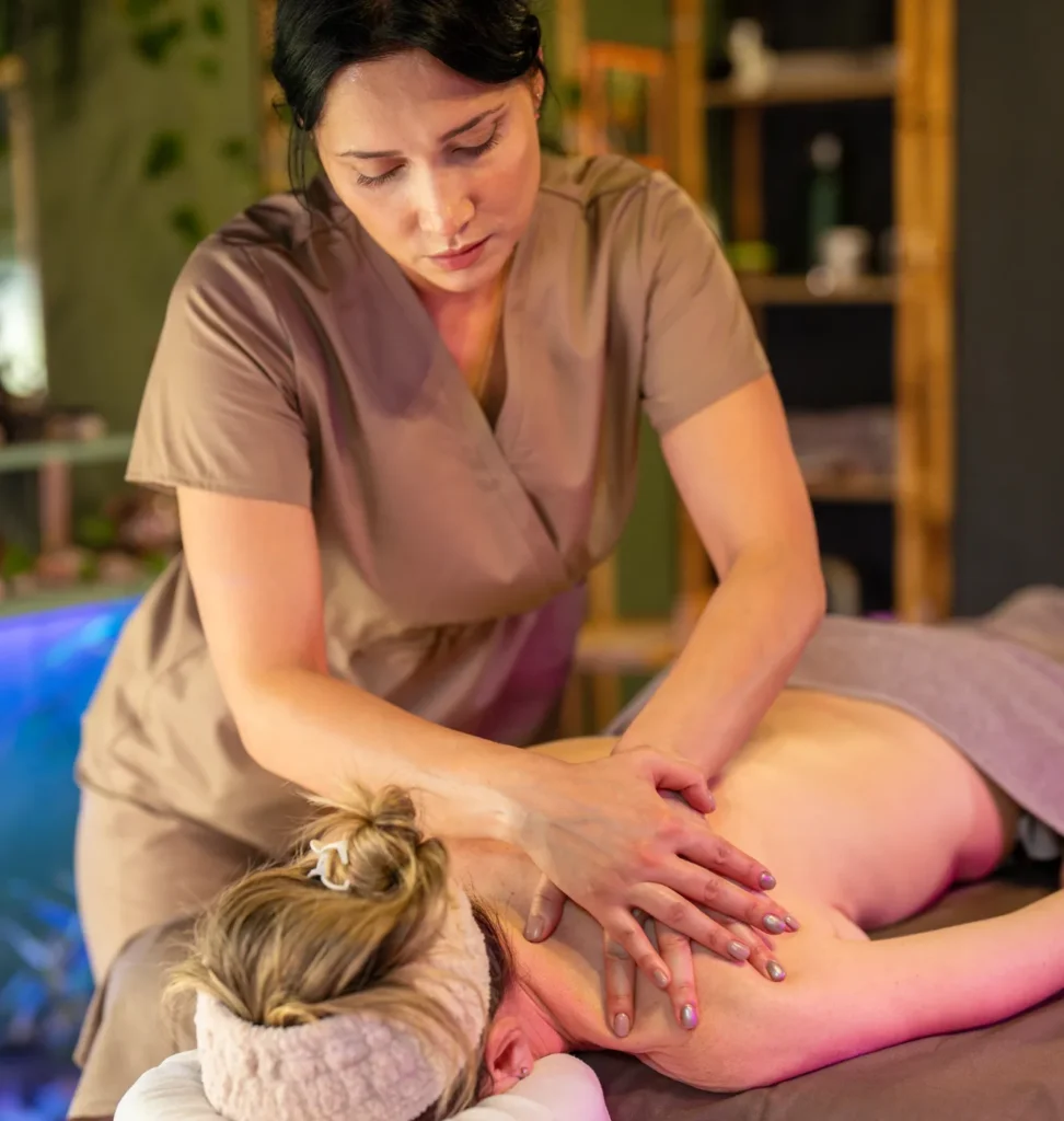 Person receiving a professional massage on a portable massage bed in an apartment in Home Massage in Al Barsha