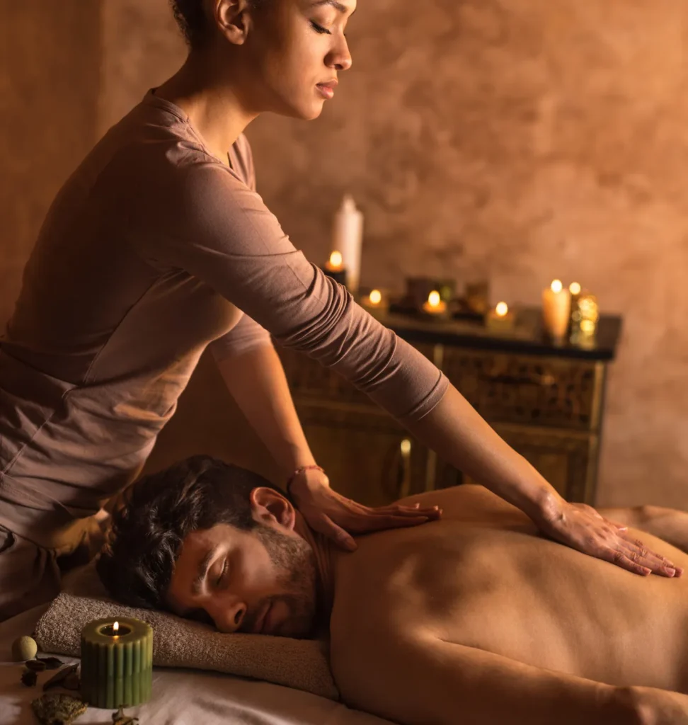 Person receiving a professional massage on a portable massage bed in an apartment in Home Massage in Person receiving a professional massage on a portable massage bed in an apartment in Home Massage in Al Quoz