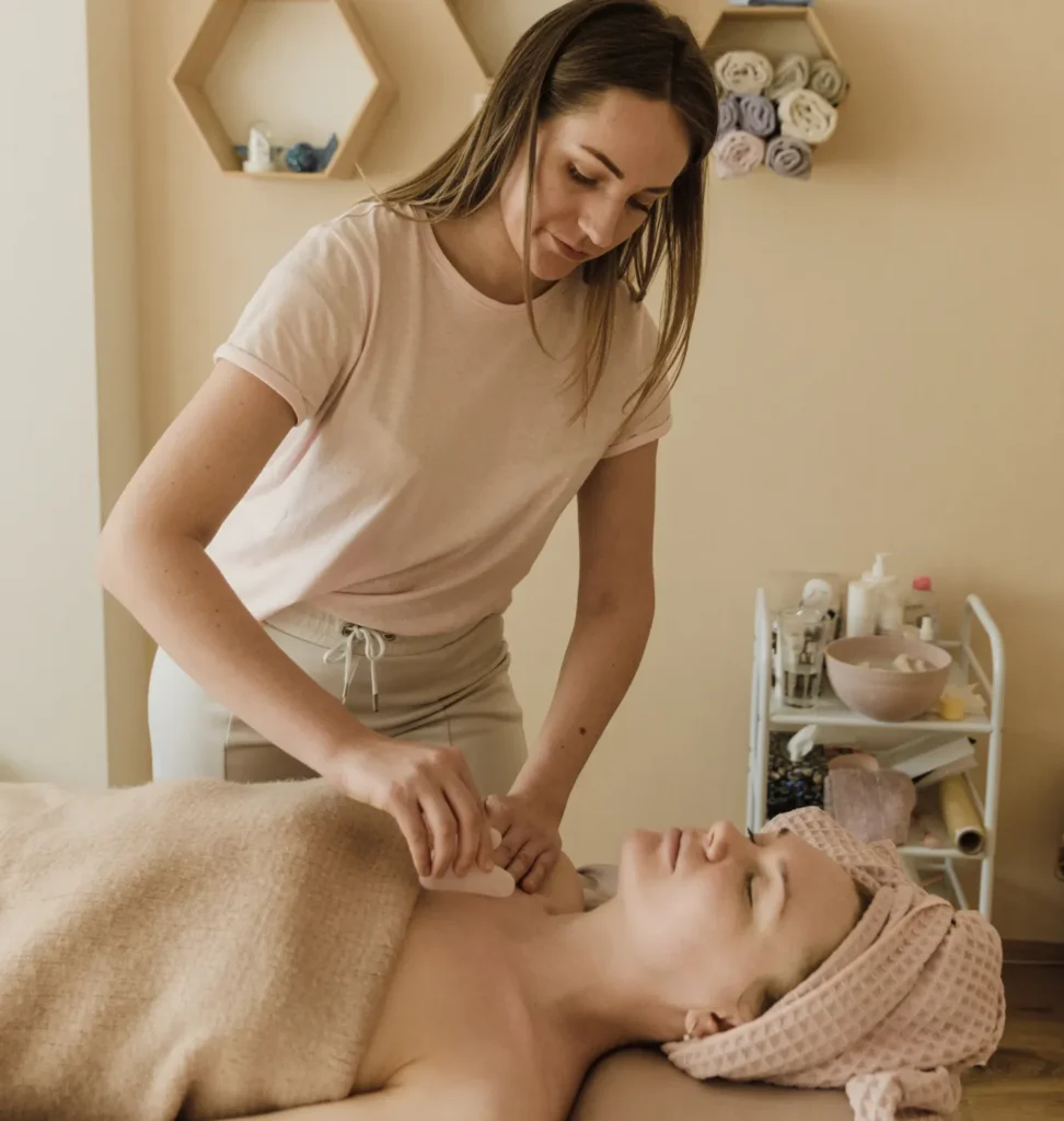 Person receiving a professional massage on a portable massage bed in an apartment in Home Massage Barsha Heights