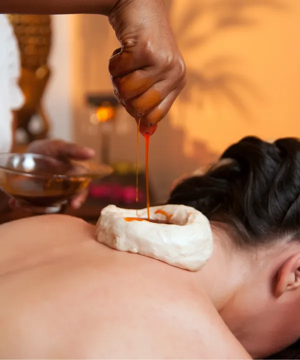 Person receiving a professional massage on a portable massage bed in an apartment in Home Massage Barsha Heights