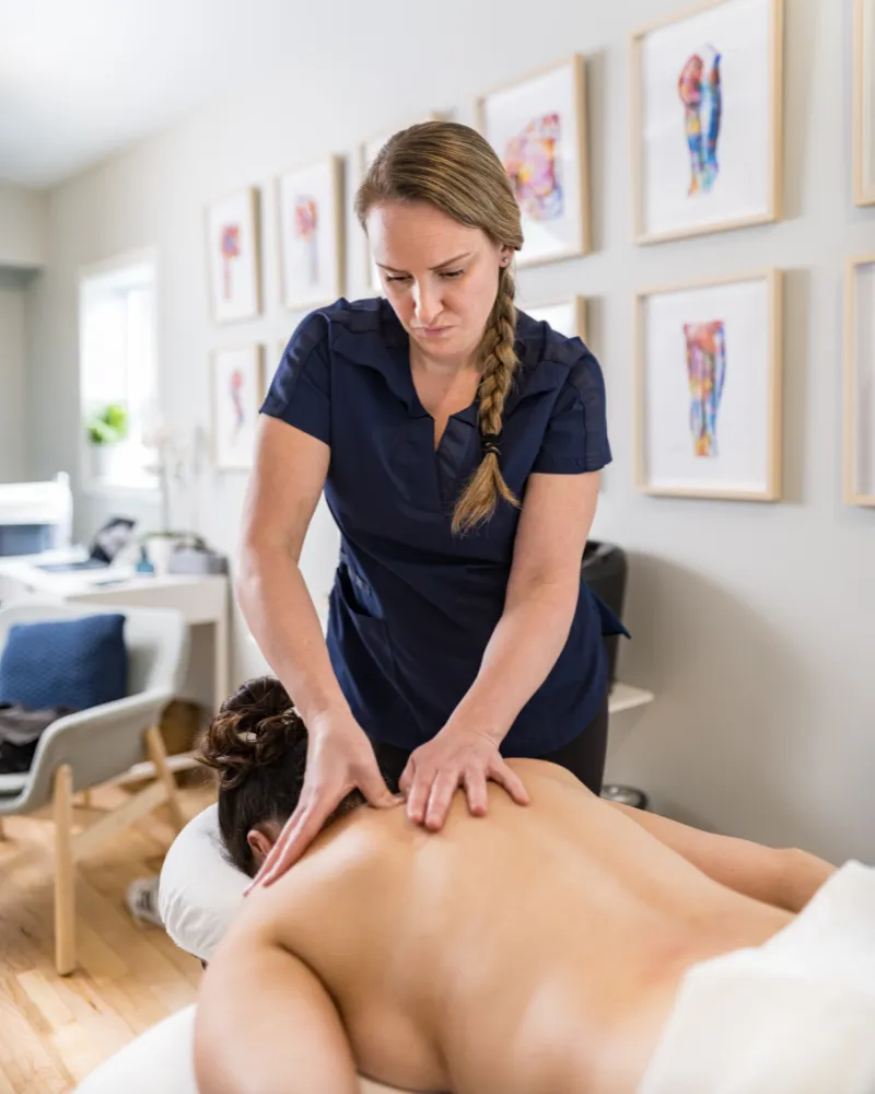 Person receiving a professional massage on a portable massage bed in an apartment in Downtown Dubai.