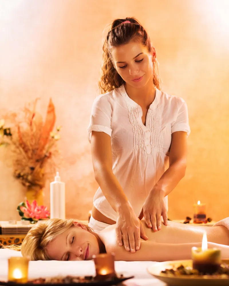 Person receiving a professional massage on a portable massage bed in an apartment in Downtown Dubai.
