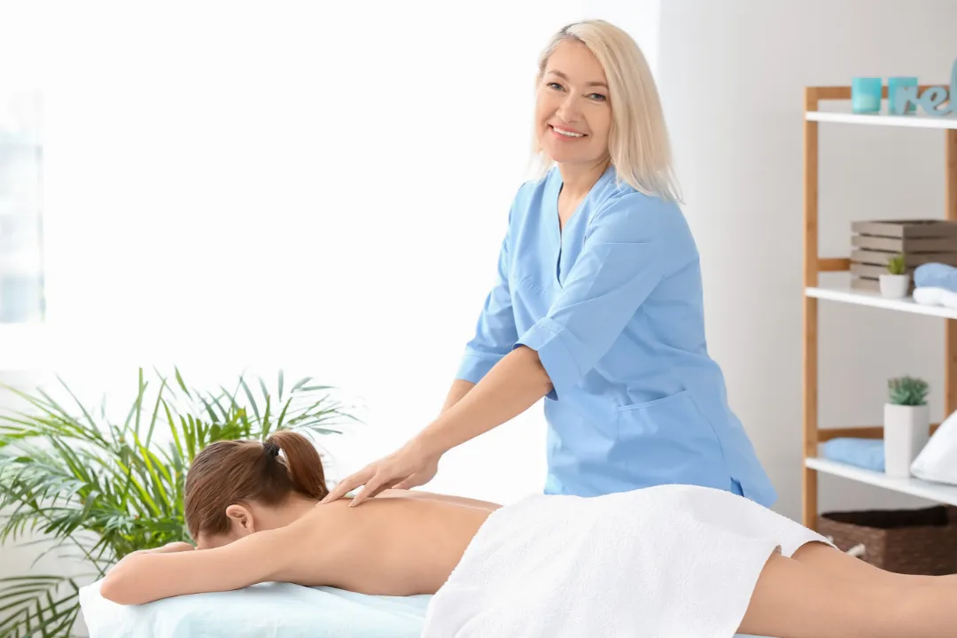 Person receiving a professional massage on a portable massage bed in an apartment in Home Massage in Person receiving a professional massage on a portable massage bed in an apartment in Home Massage in Dubai Media City