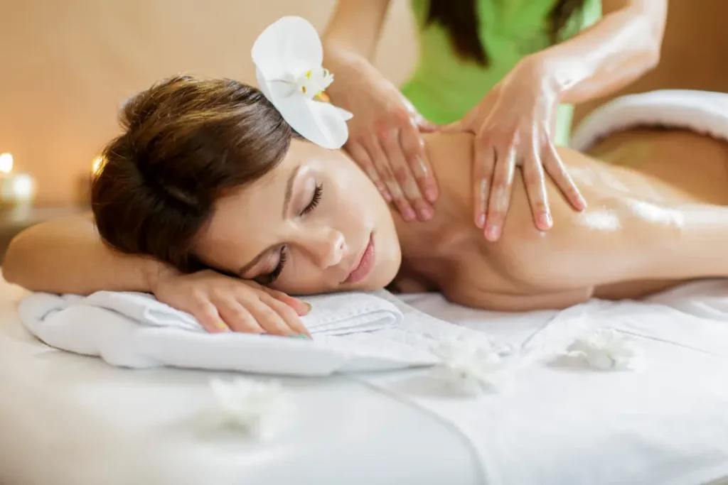 Person receiving a professional massage on a portable massage bed in an apartment in Dubai JLT
