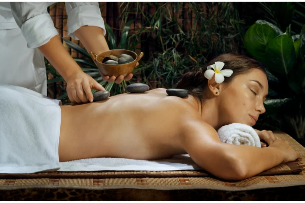 Person receiving a professional massage on a portable massage bed in an apartment in Home Massage in JVC Dubai