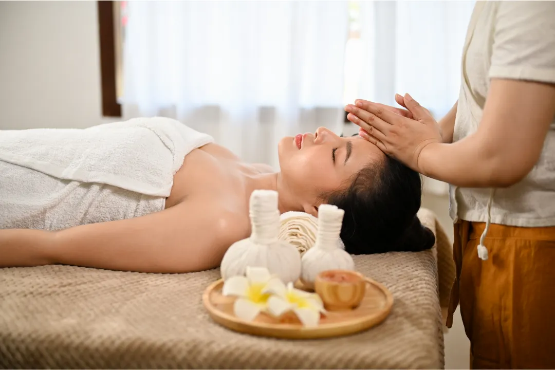 Person receiving a professional massage on a portable massage bed in an apartment in Home Massage in Mirdif