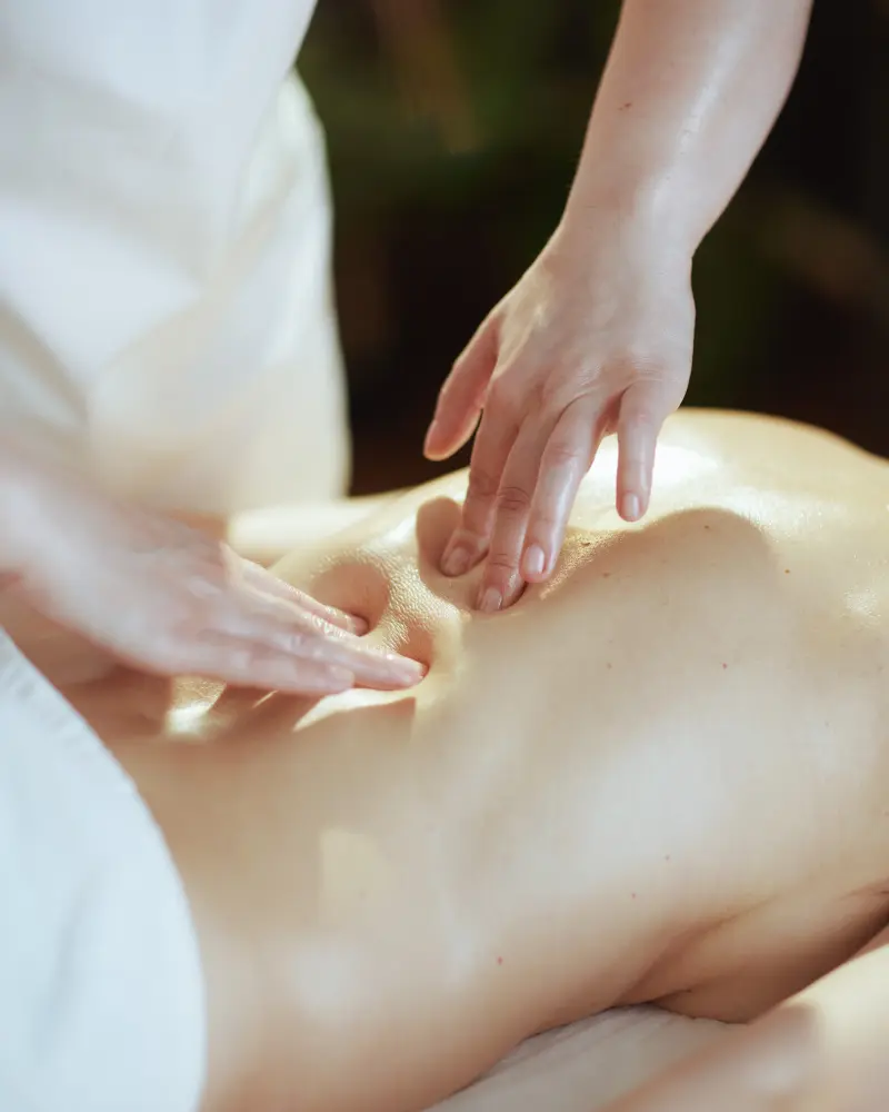 Person receiving a professional massage on a portable massage bed in an apartment in Home Massage in Dubai Hills