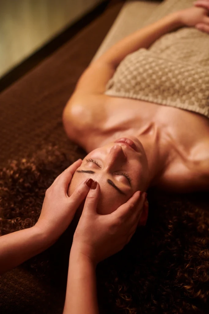 Person receiving a professional massage on a portable massage bed in an apartment in Dubai Marina.
