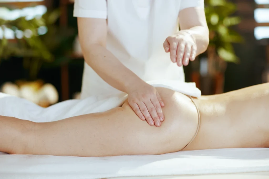 Person receiving a professional massage on a portable massage bed in an apartment in Dubai Marina.