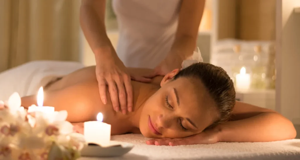 Person receiving a professional massage on a portable massage bed in an apartment in Dubai JBR.