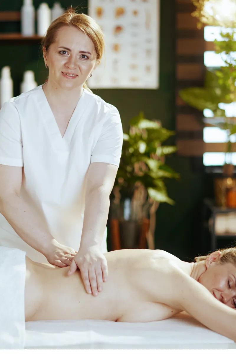 Person receiving a professional massage on a portable massage bed in an apartment in Dubai JBR.