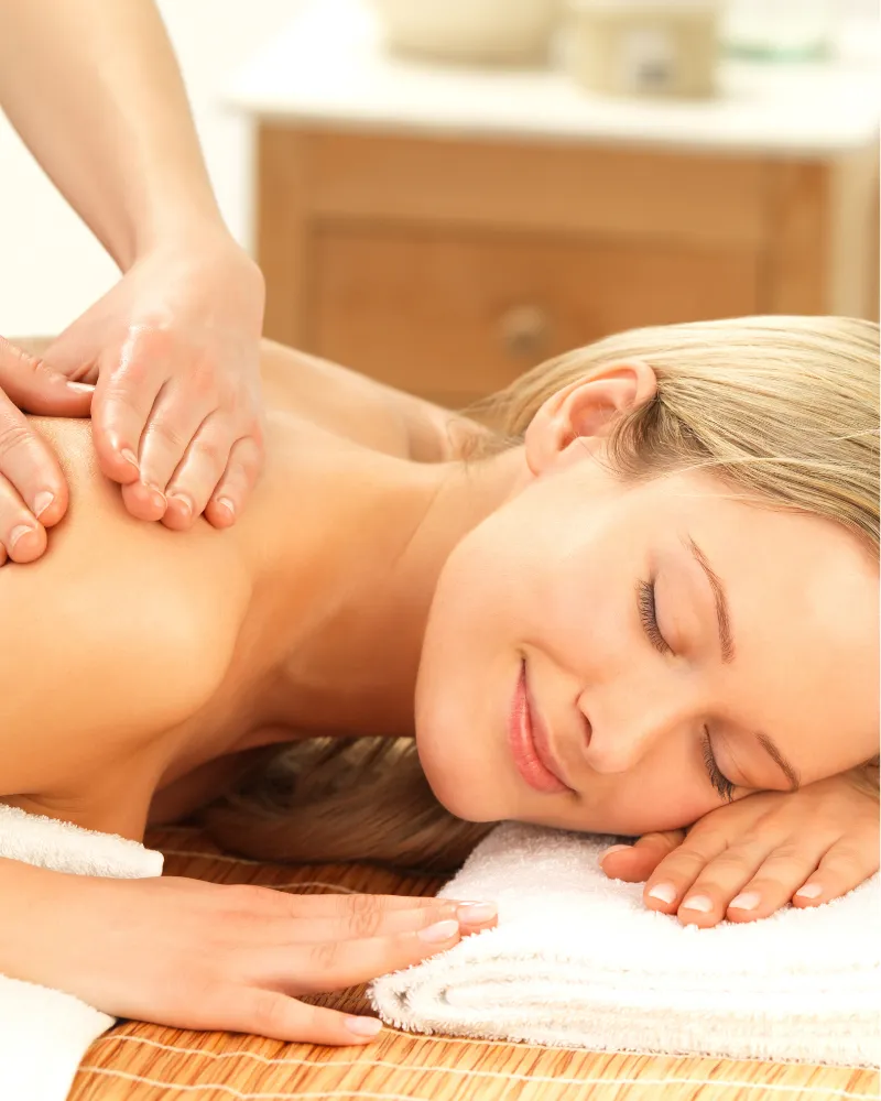 Person receiving a professional massage on a portable massage bed in an apartment in Dubai JBR.