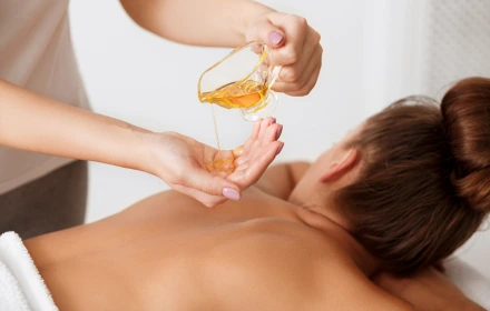 Person receiving a professional massage on a portable massage bed in an apartment in Dubai JBR.