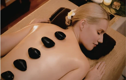 Person receiving a professional massage on a portable massage bed in an apartment in Dubai JBR.