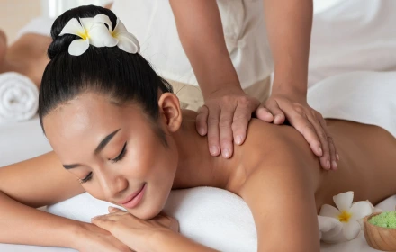 Person receiving a professional massage on a portable massage bed in an apartment in Dubai JBR.