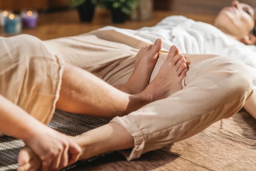 This person is geting Sports Massage on a portable Massage bed in his apartnent in dubai.