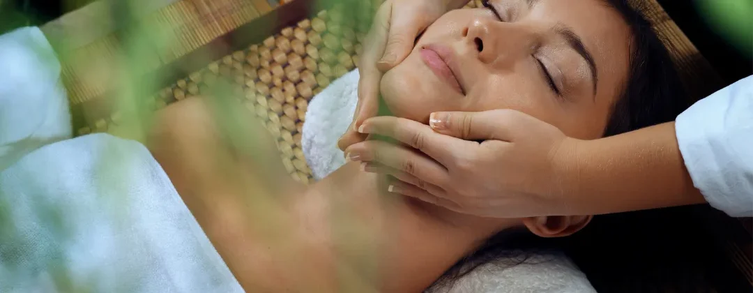 Person receiving a professional massage on a portable massage bed in an apartment in Home Massage in Al Barsha