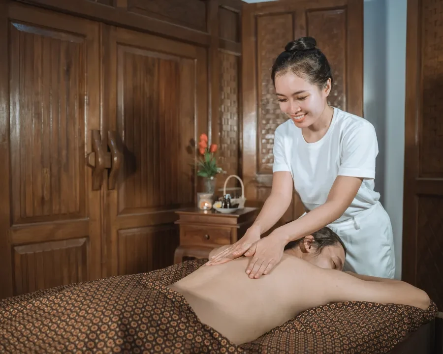Person receiving a professional massage on a portable massage bed in an apartment in Home Massage in Person receiving a professional massage on a portable massage bed in an apartment in Home Massage in Dubai Media City