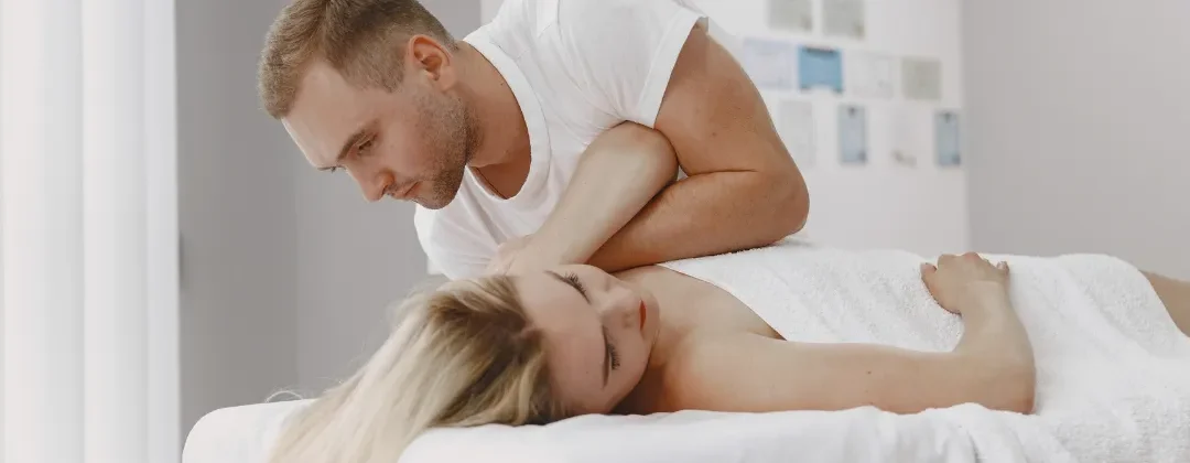Person receiving a professional massage on a portable massage bed in an apartment in Home Massage in Person receiving a professional massage on a portable massage bed in an apartment in Home Massage in JVT Dubai