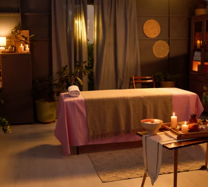 Person receiving a professional massage on a portable massage bed in an apartment in Home Massage in Mirdif