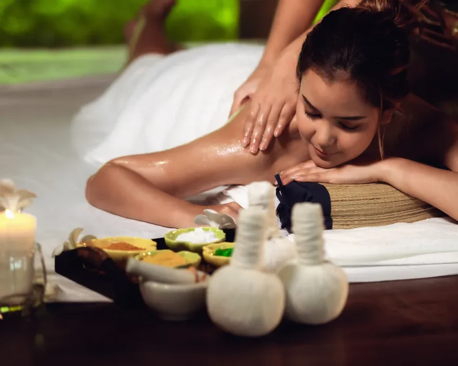 Person receiving a professional massage on a portable massage bed in an apartment in Home Massage in Mirdif