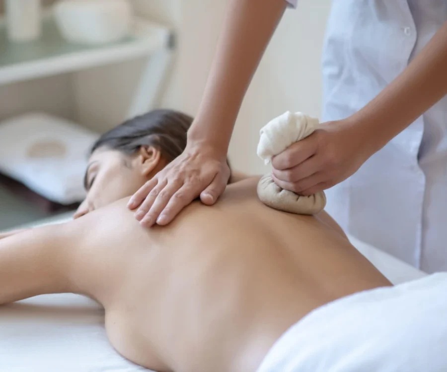 Person receiving a professional massage on a portable massage bed in an apartment in Home Massage in Palm Jumeirah