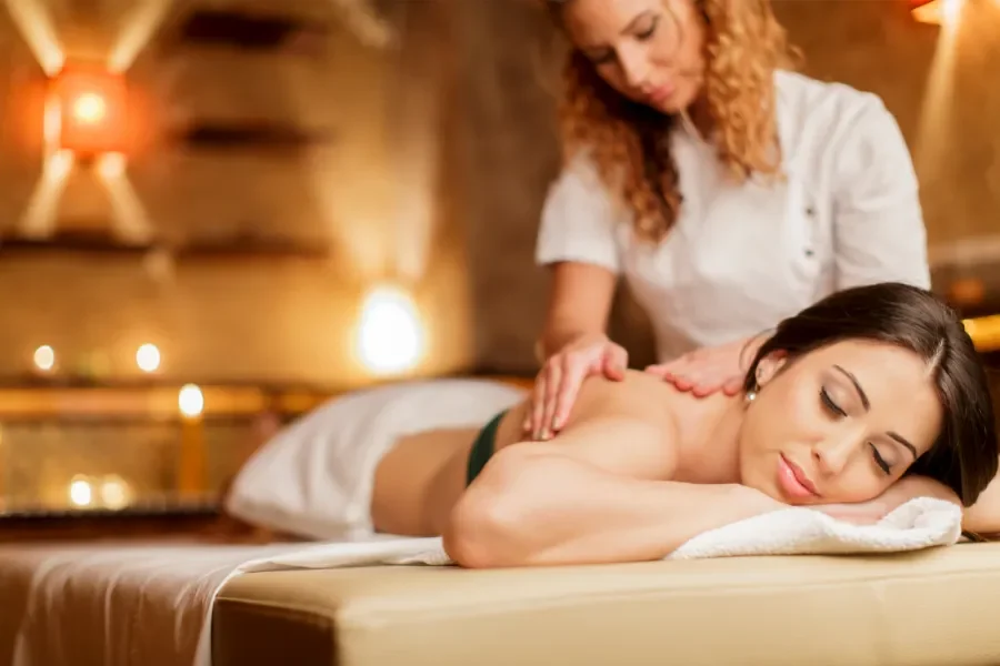 Person receiving a professional massage on a portable massage bed in an apartment in Home Massage in Person receiving a professional massage on a portable massage bed in an apartment in Home Massage in Arabian Ranches