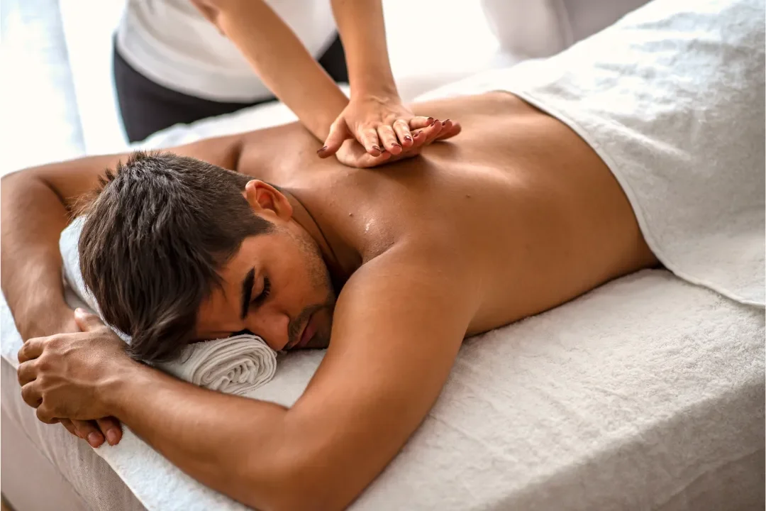 Person receiving a professional massage on a portable massage bed in an apartment in Home Massage in Person receiving a professional massage on a portable massage bed in an apartment in Home Massage in DIFC