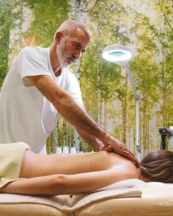 Person receiving a professional massage on a portable massage bed in an apartment in Home Massage in Person receiving a professional massage on a portable massage bed in an apartment in Home Massage in Motor City